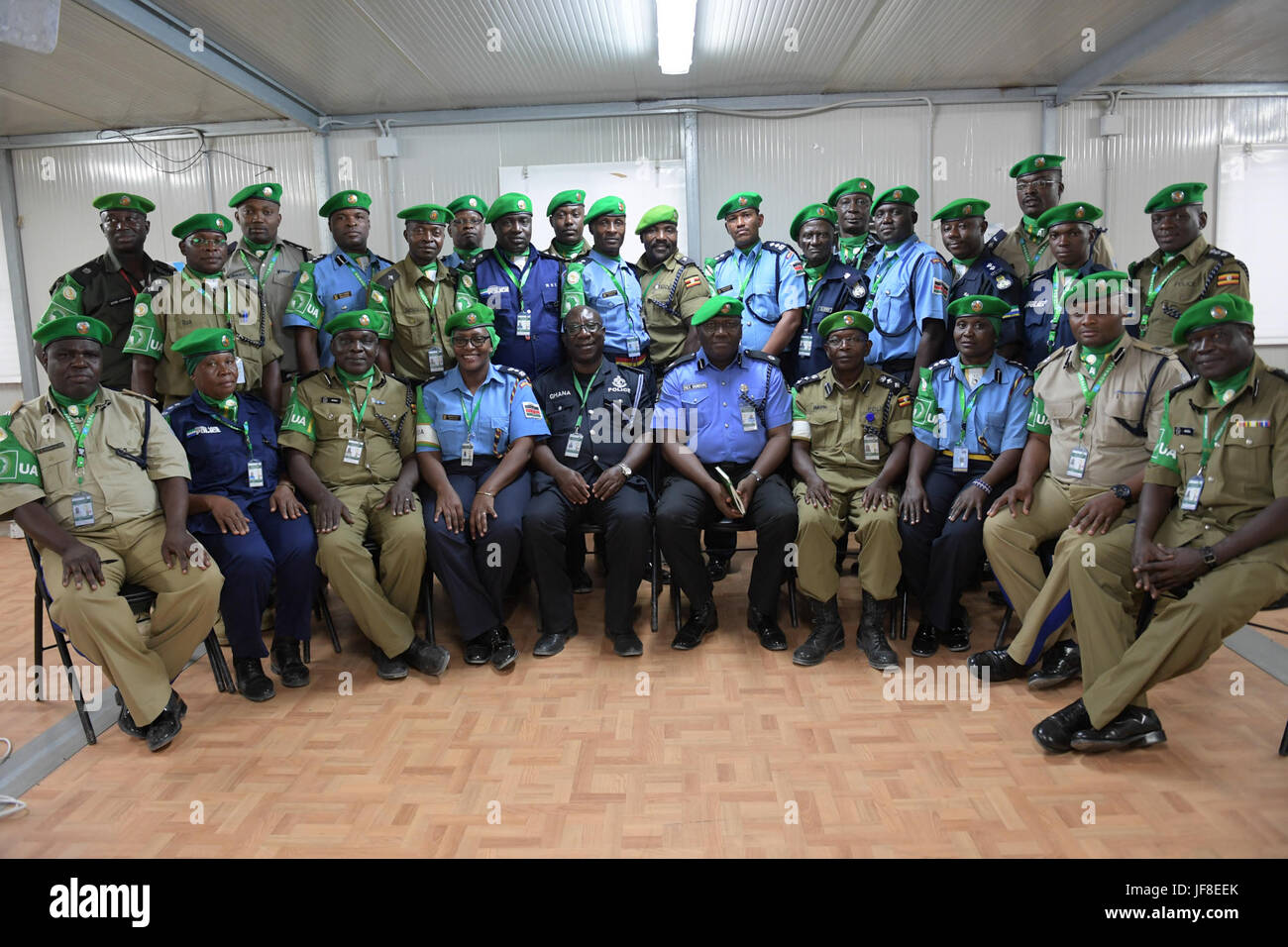 Individual Police Officers (IPOs) from Zambia, Kenya, Sierra Leone and Uganda pose for a group photograph with AMISOM Police Chief of Staff, Rex Dundun, and other AMISOM Police officials after the completion of the eight-day Individual Police Officers induction training in Mogadishu, Somalia on 18th May 2017. AMISOM Photo/Atulinda Allan Stock Photo