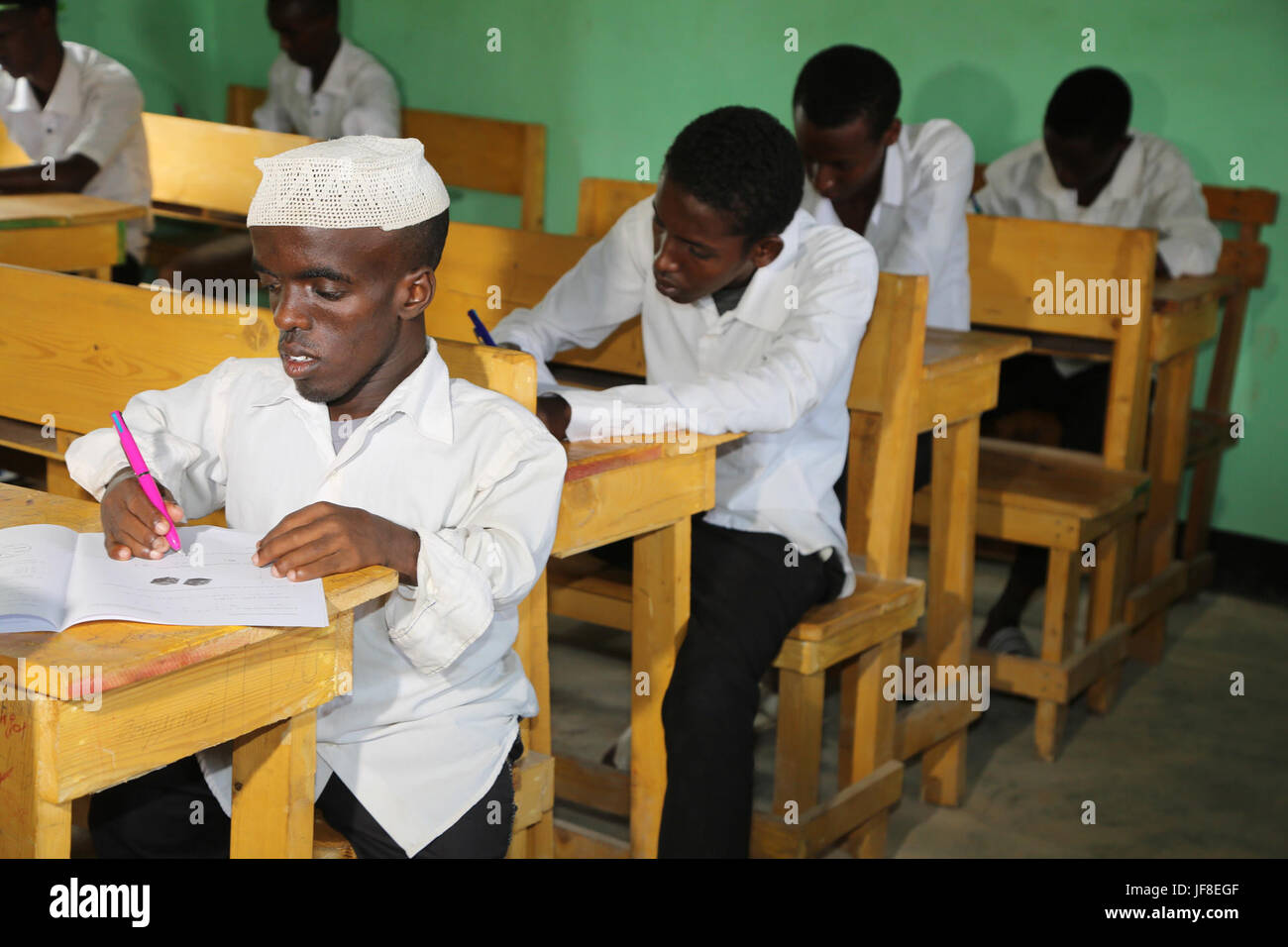Students sit for their final term exam at Mujama Secondary School in Beledweyne, Somalia, on May 22, 2017. AMISOM Photo Stock Photo
