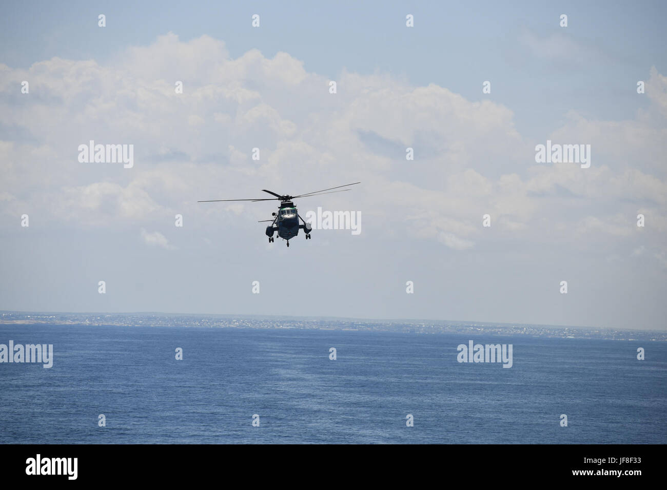 A Galicia Sea King helicopter belonging to the European Union (EU) Naval Force conducts airlifting manoeuvers on the Indian Ocean off the coast of Somalia on May 8, 2017. The EU Naval Force is engaged in counter-piracy operations in the Indian Ocean. AMISOM photo / Omar Abdisalan Stock Photo