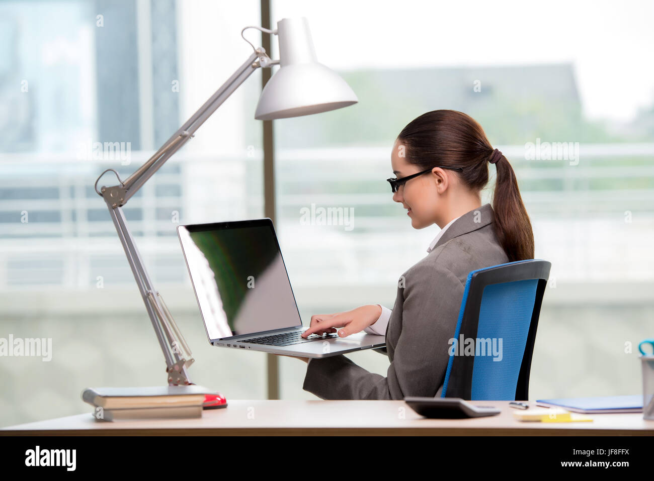 Businesswoman working at her desk Stock Photo - Alamy