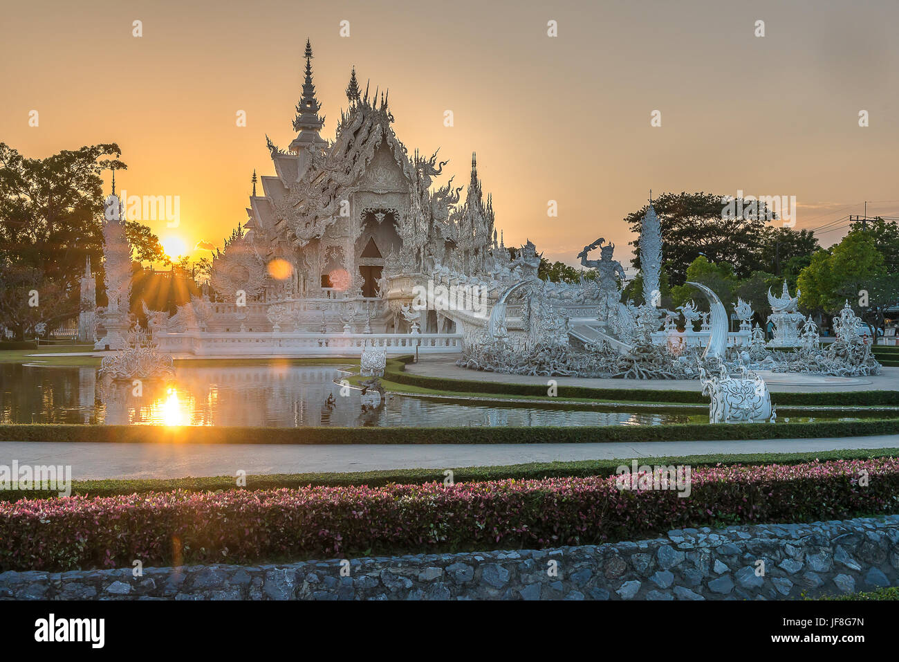 Wat Rong Khun, The White Temple, in Chiang Rai Thailand during sunset Stock Photo