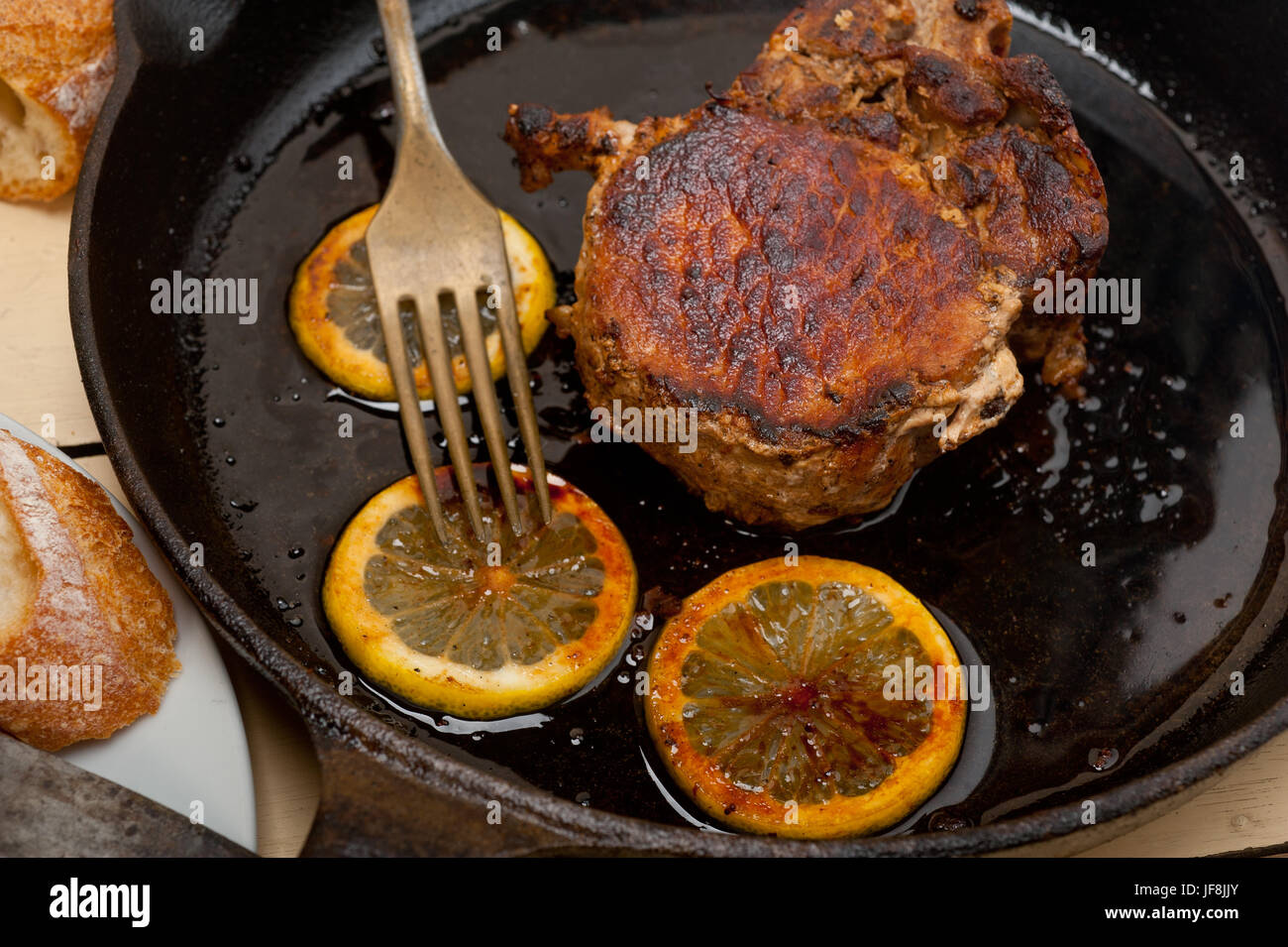 pork chop seared on iron skillet Stock Photo Alamy
