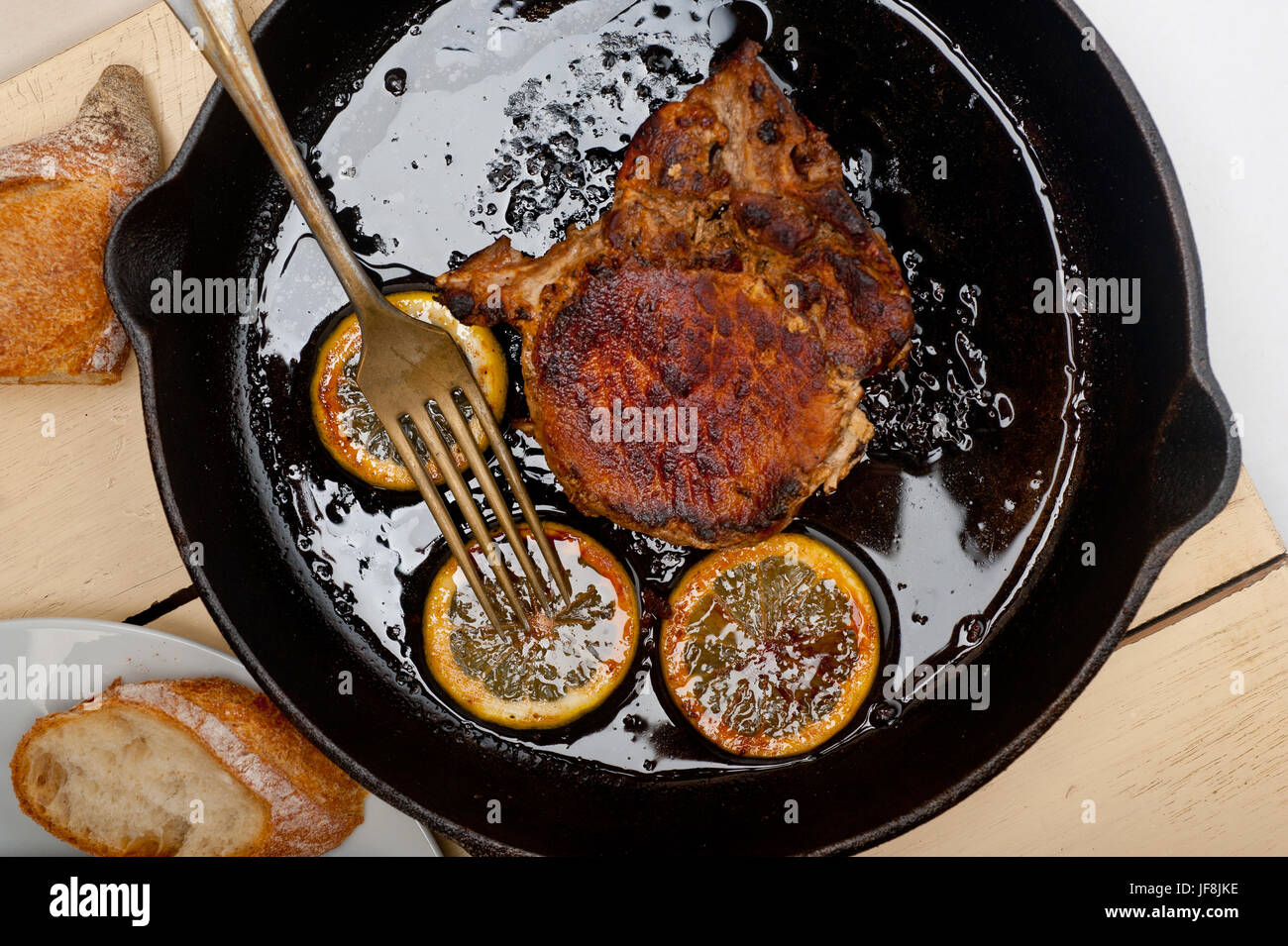 pork chop seared on iron skillet Stock Photo Alamy