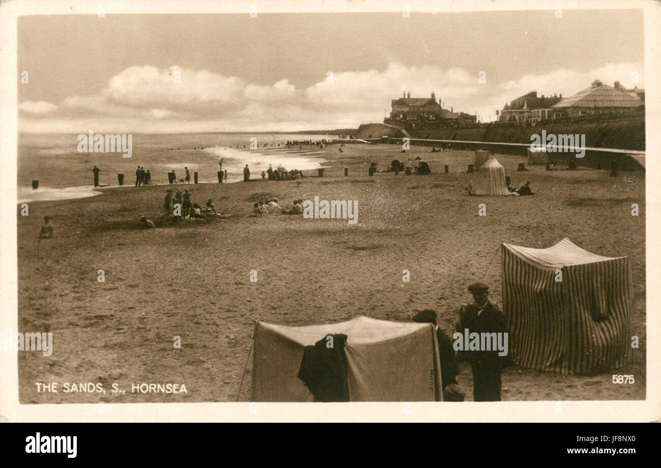 The Sands at Hornsea, a picturesque seaside resort town in England, photographed in 1910 as a popular vacation spot. #Hornsea #SeasideResort Stock Photo