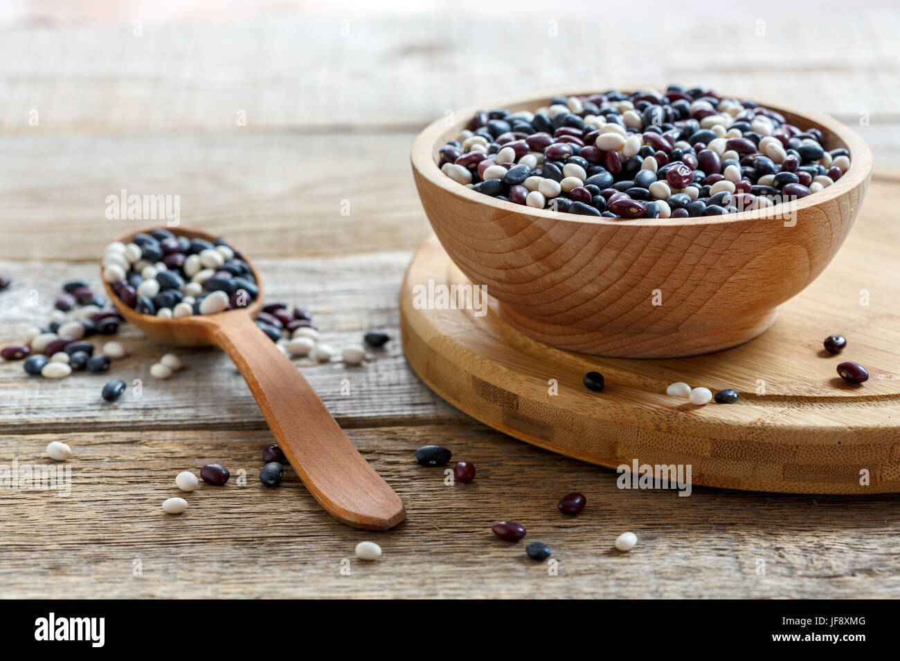 Mixture of colorful beans in a wooden bowl. Stock Photo