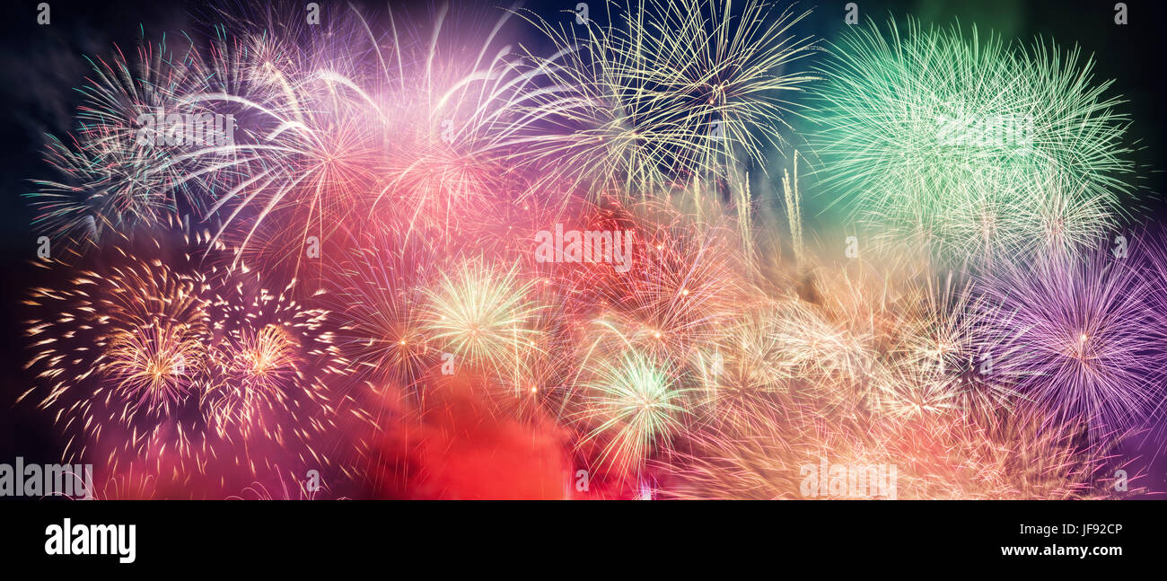 Spectacular fireworks show light up the sky. New year celebration panoramic background Stock Photo