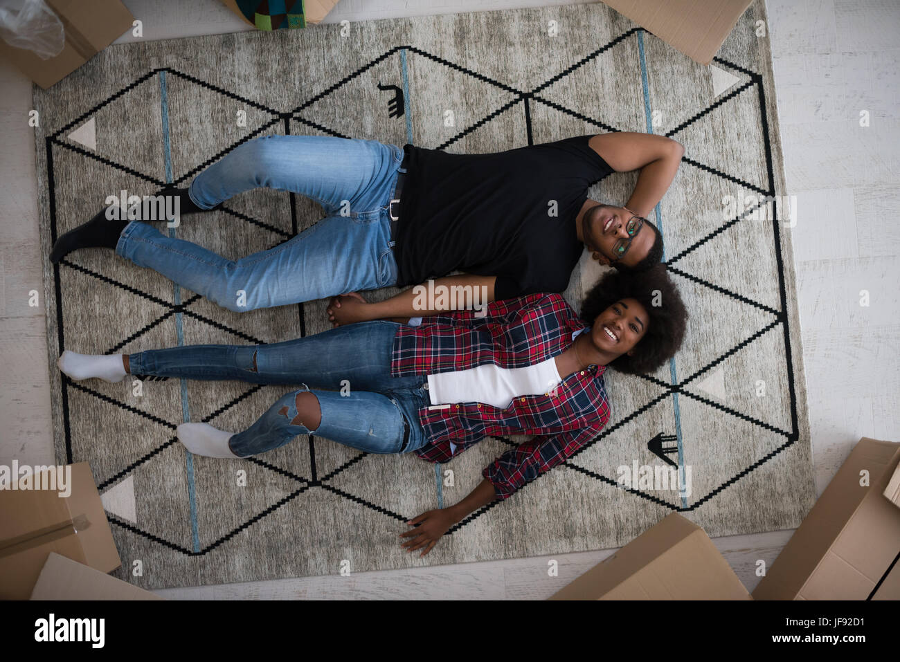 Top view of attractive young African American couple moving, holding ...