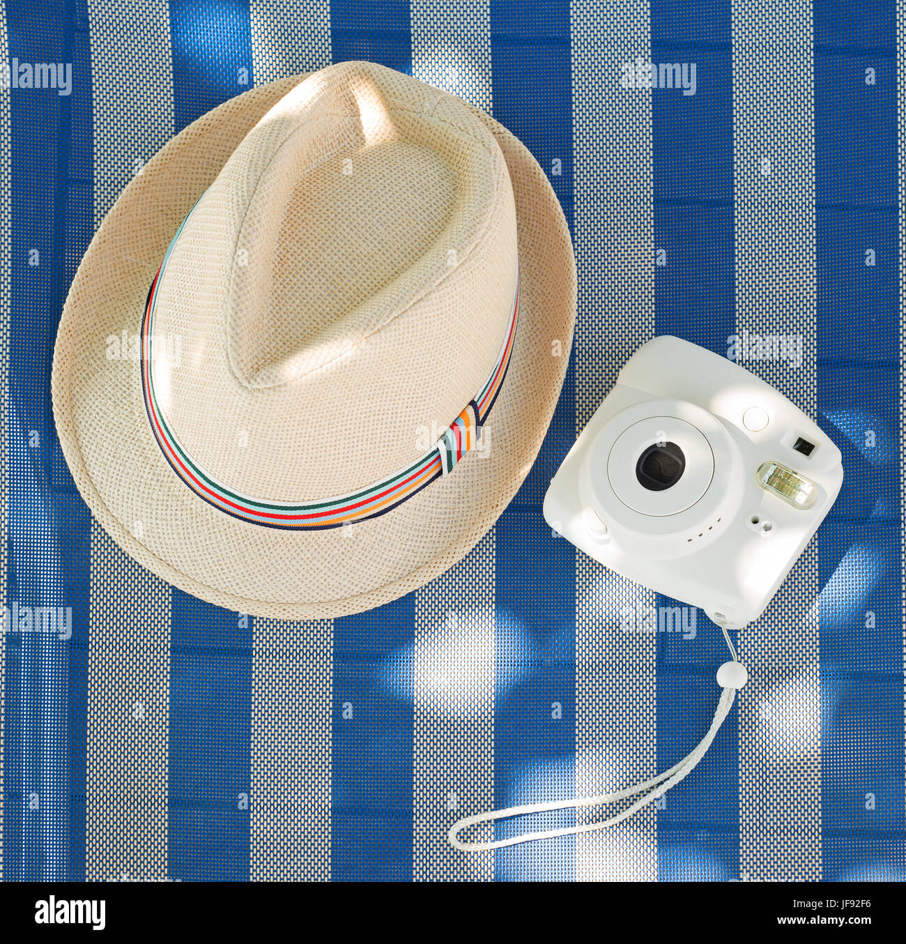 Beach accessories. Hat, Instant camera and deck chair Stock Photo