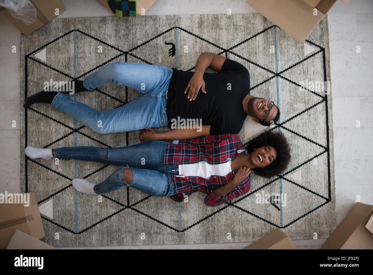 Top view of attractive young African American couple moving, holding ...