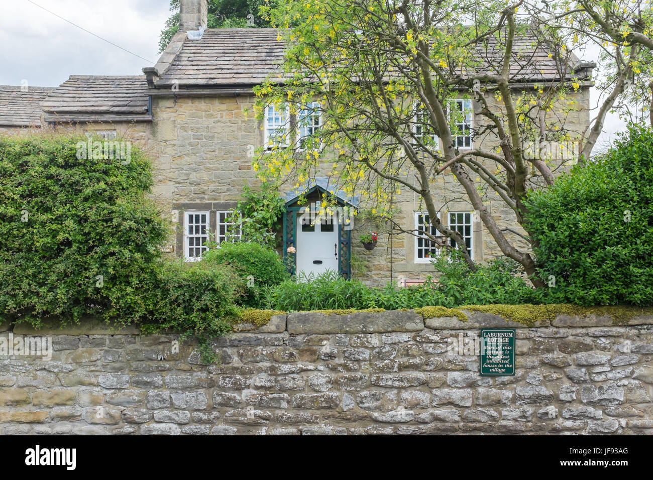 Laburnum Cottage, the oldest inhabited house in the village of Eyam in the Derbyshire Peak District Stock Photo