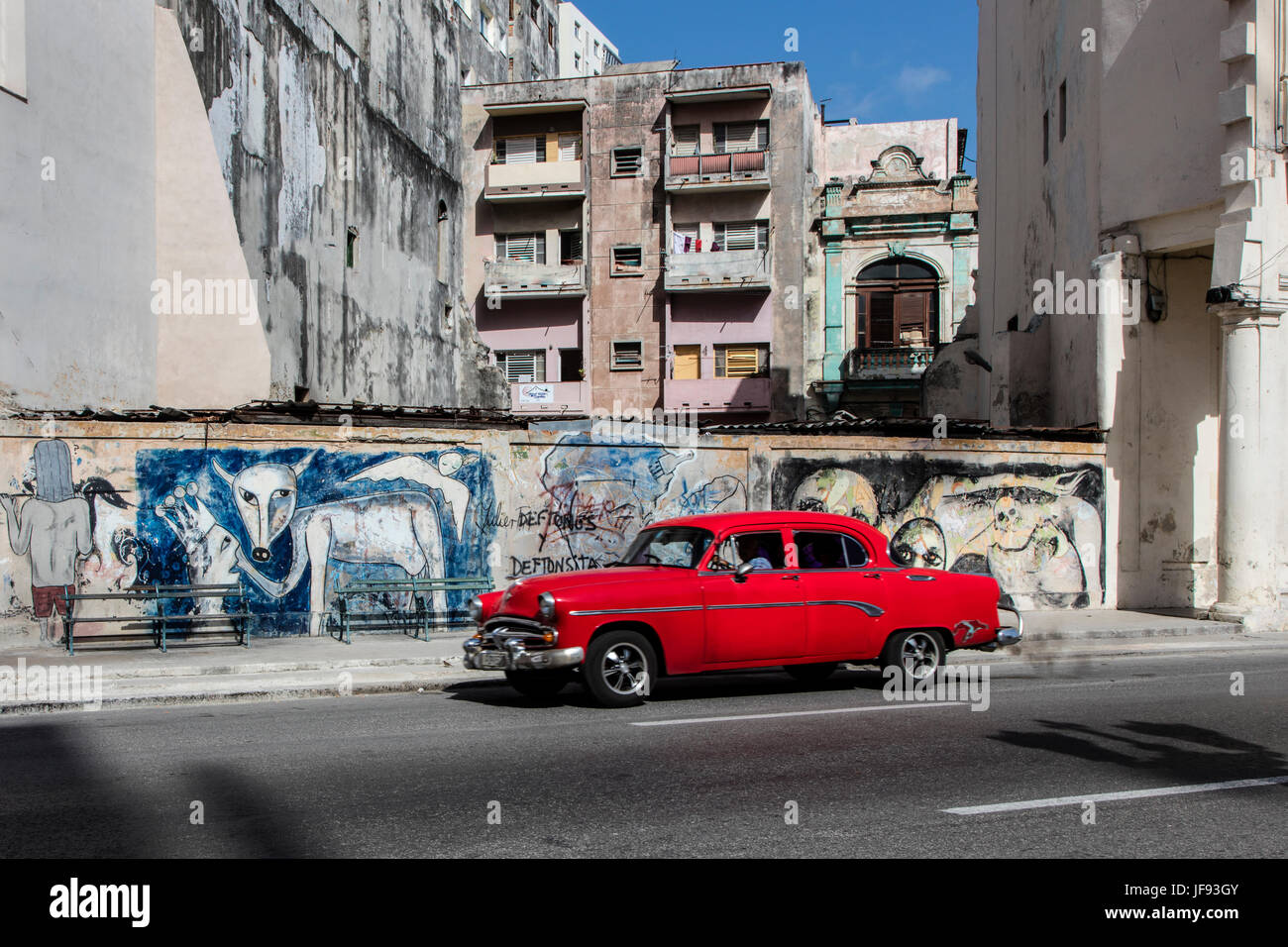 A classic car and street mural along the PASEO DE MARTI also known as the PRADO - HAVANA, CUBA Stock Photo