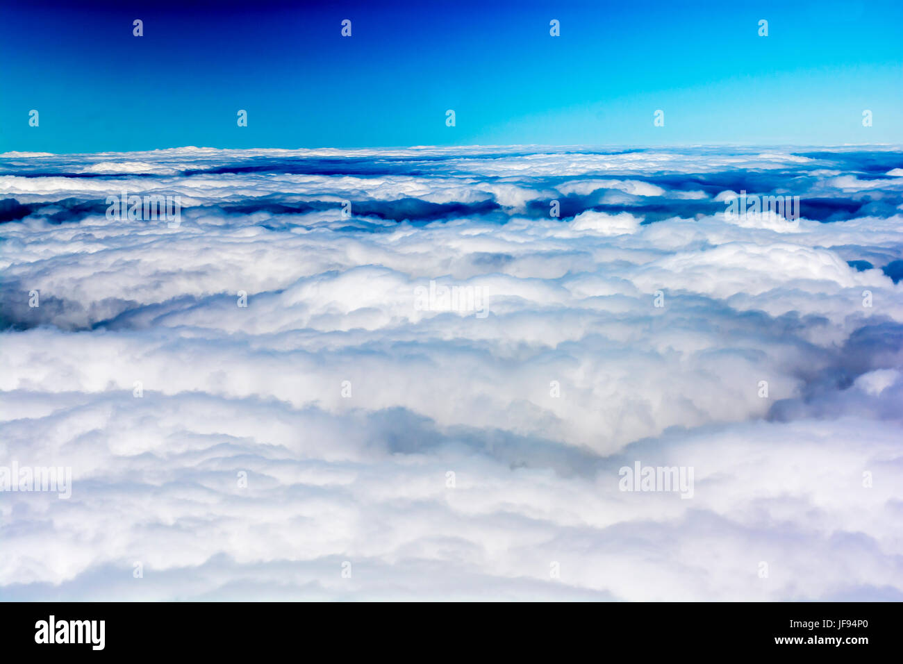Above the clouds under blue sky Stock Photo - Alamy