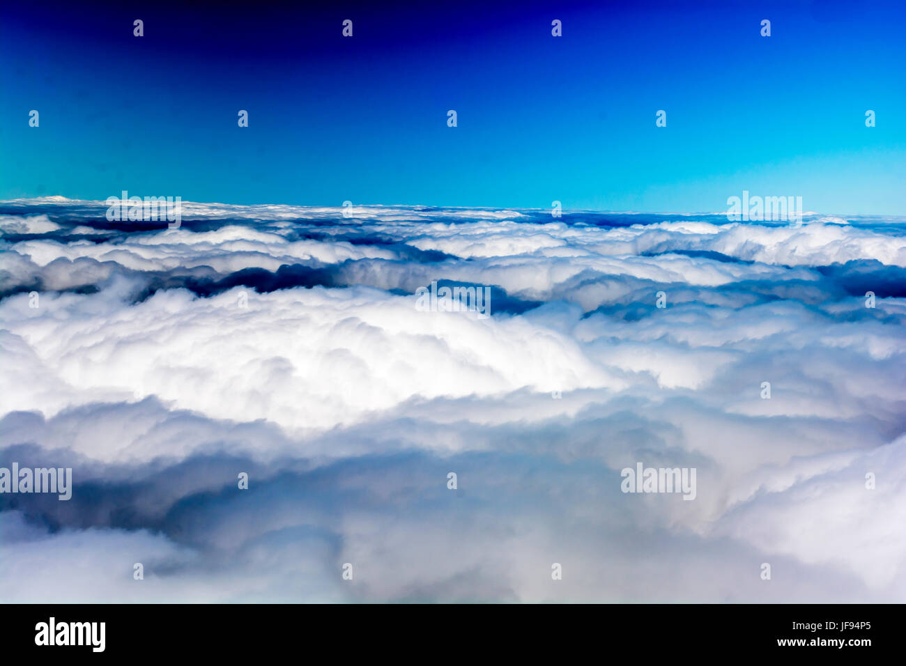 Above the clouds under blue sky Stock Photo - Alamy