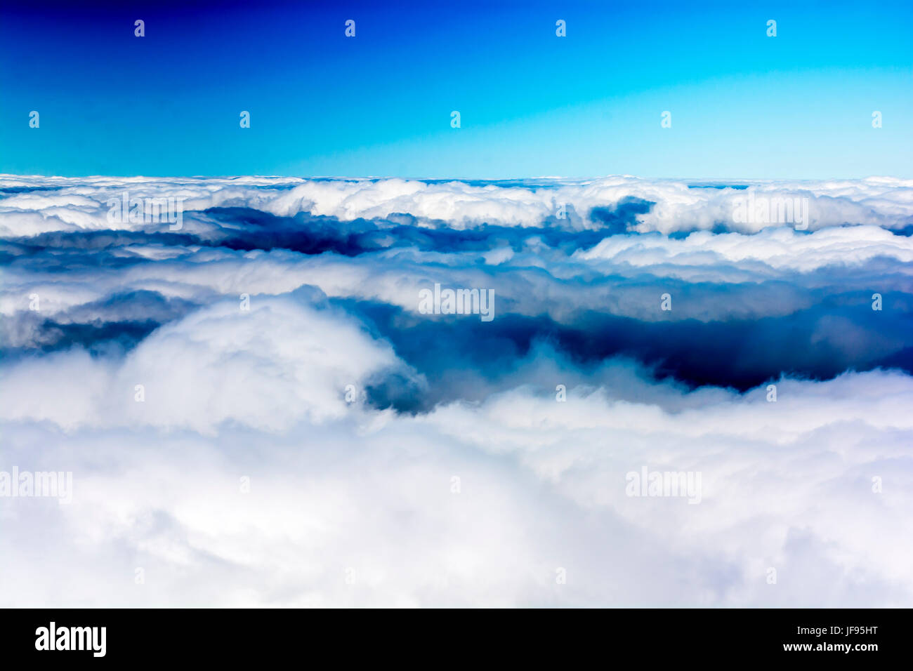 Above the clouds under blue sky Stock Photo - Alamy