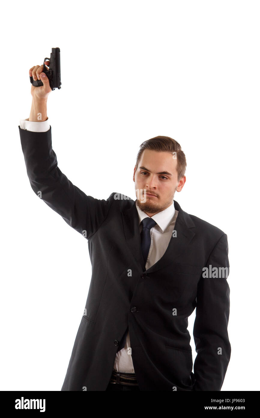 A man in a suit holding a gun in the air Stock Photo