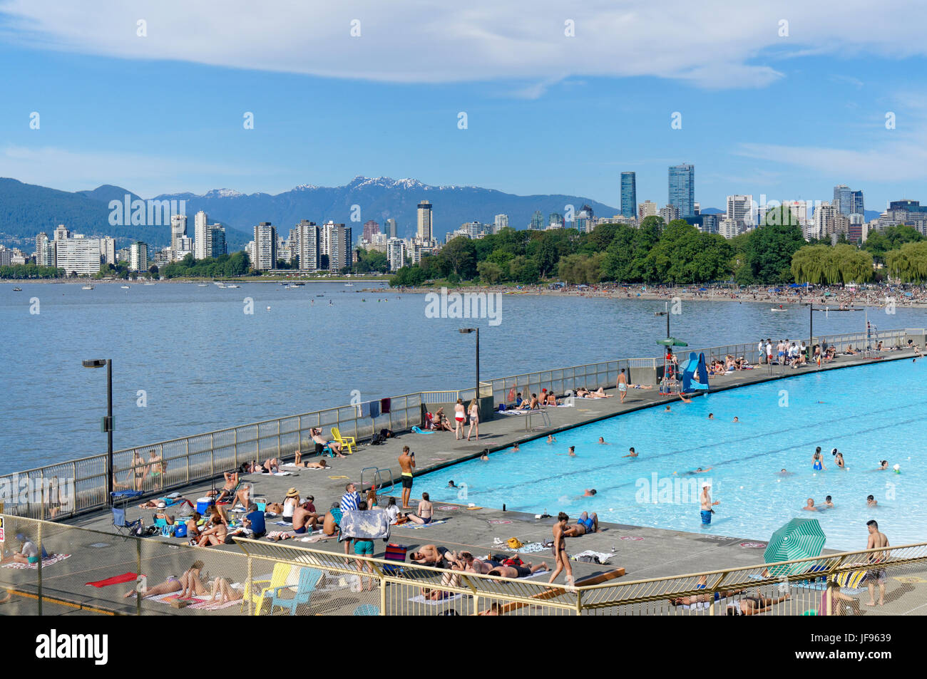 People sunbathing and swimming at Kitsilano Pool on English Bay, Vancouver, British Columbia, Canada Stock Photo