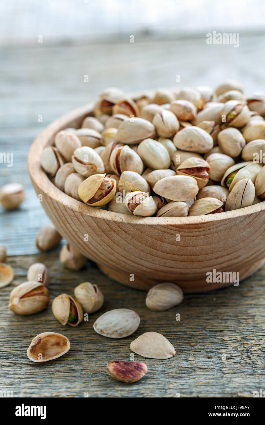 Wooden bowl with raw pistachios Stock Photo Alamy