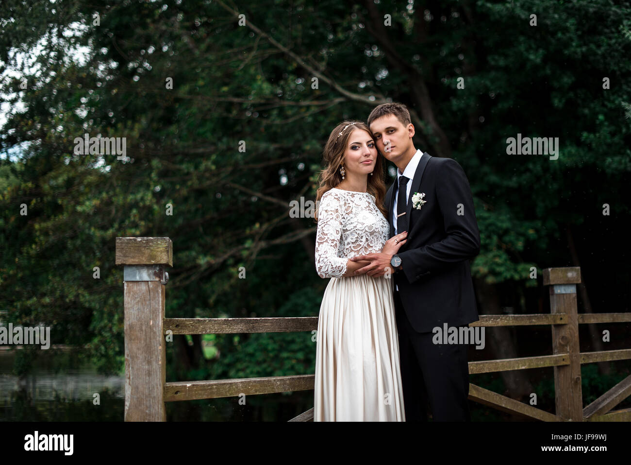 happy bride and groom at a park on their wedding day Stock Photo - Alamy