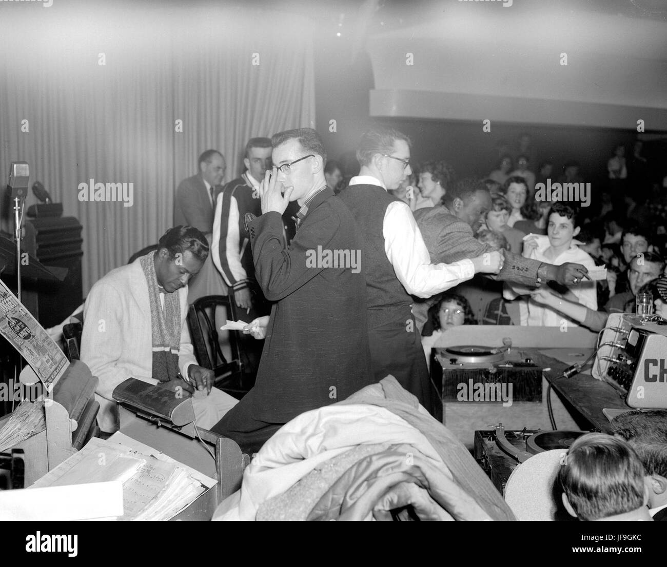 A vintage photograph of Chuck Berry (far left) signing autographs at Edmonton Gardens, capturing a moment of rock 'n' roll history Stock Photo