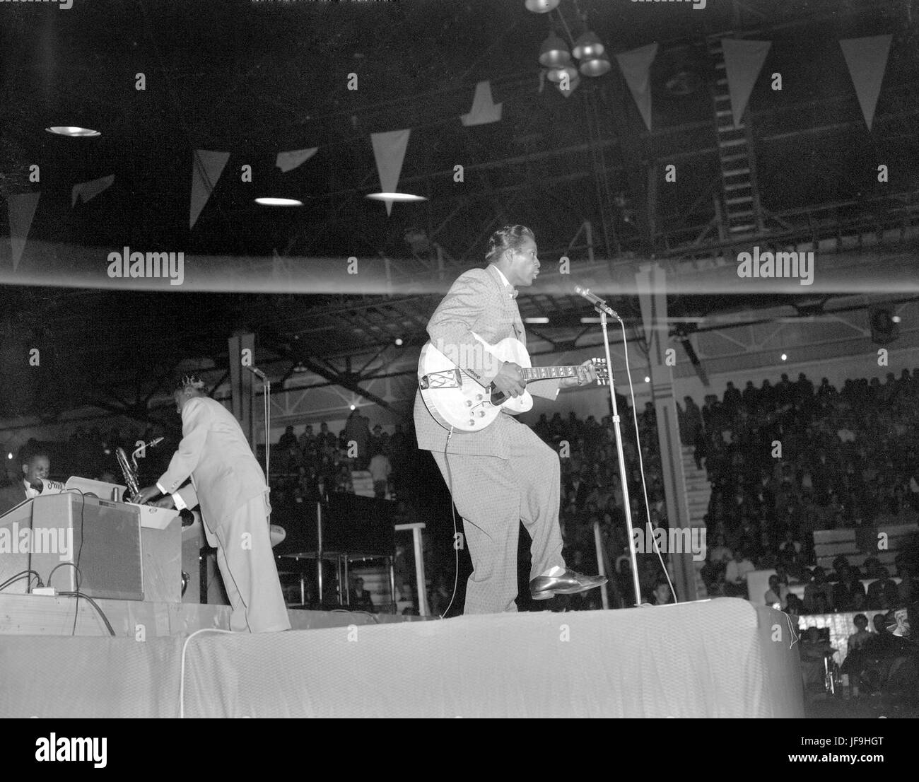 An iconic photograph of Chuck Berry performing live at the Edmonton Gardens in Alberta, capturing the energy of a rock and roll legend on stage. Stock Photo