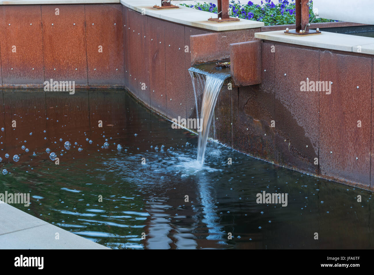 Water supply for a garden pond. Stock Photo