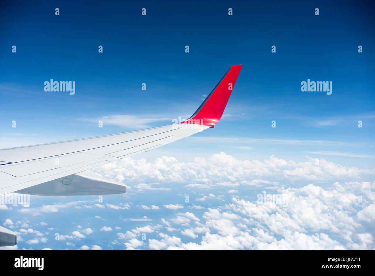 airplane wing above the clouds Stock Photo