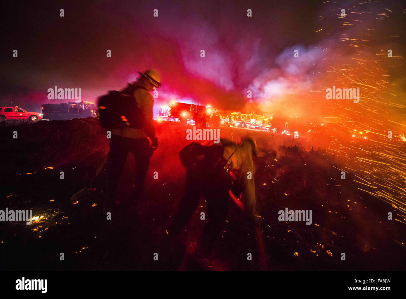 San Clemente, California, USA. 28th June, 2017. Firefighters put out hotspots while working to