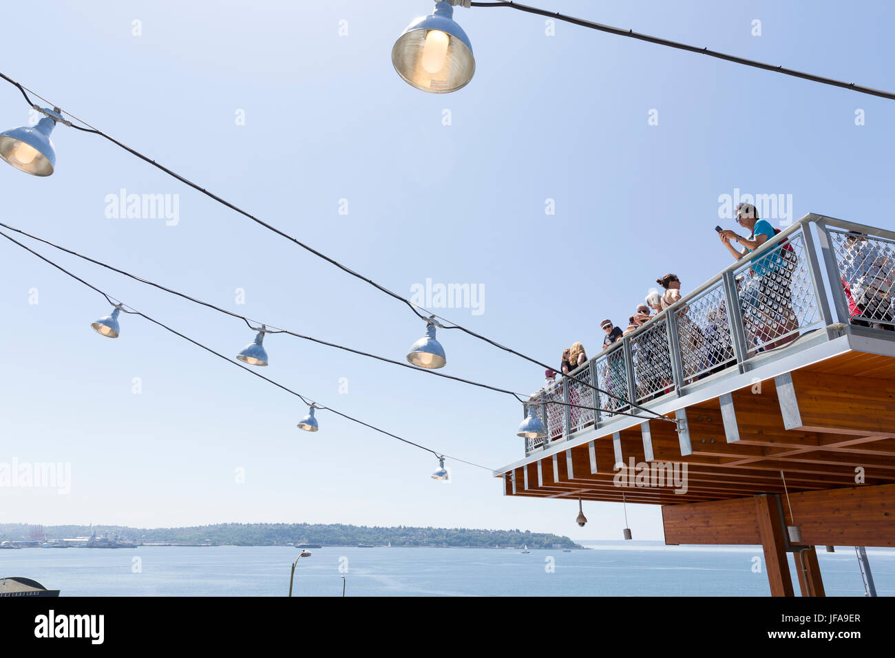 Seattle, United States. 29th June, 2017. Seattle, Washington: Crowd gathered on the plaza overlooking Elliott Bay at Pike Place MarketFront's grand opening. The $74 million MarketFront expansion provides a dynamic public plaza with views of Puget Sound and Olympic Mountains as well as table space for farmers, craftspeople and artisan purveyors, retail space, low-income housing, a neighborhood center and parking. The project was created in accordance of Market historic district guidelines and the Pike Place Market charter. Credit: Paul Christian Gordon/Alamy Live News Stock Photo