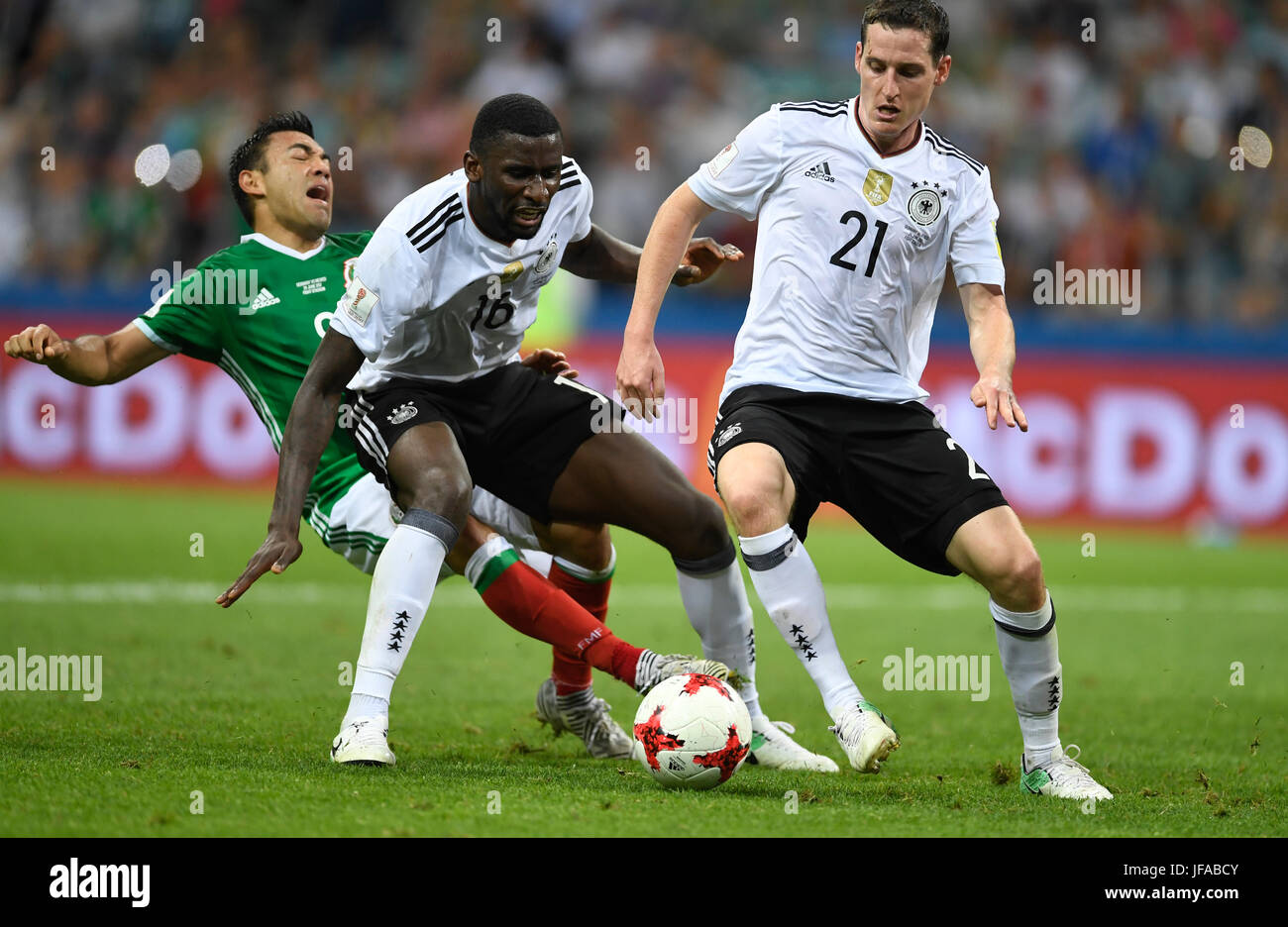 Sochi, Russia. 29th June, 2017. Germany's Antonio Ruediger (C) and Sebastian Rudy (R) vie for the ball against Mexico's Marco Fabian during the Confederations Cup semi-final between Germany and Mexico at the Fisht Stadium in Sochi, Russia, 29 June 2017. Photo: Marius Becker/dpa/Alamy Live News Stock Photo