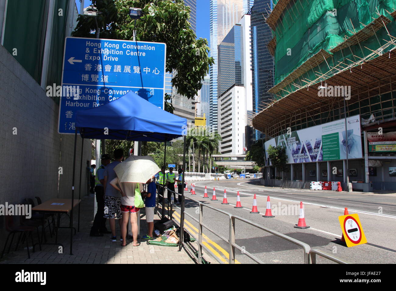 Pedestrians were told by police not to walk ahead to the Grand Hyatt where President Xi Jinping was staying in Hong Kong, but to take detours. Stock Photo