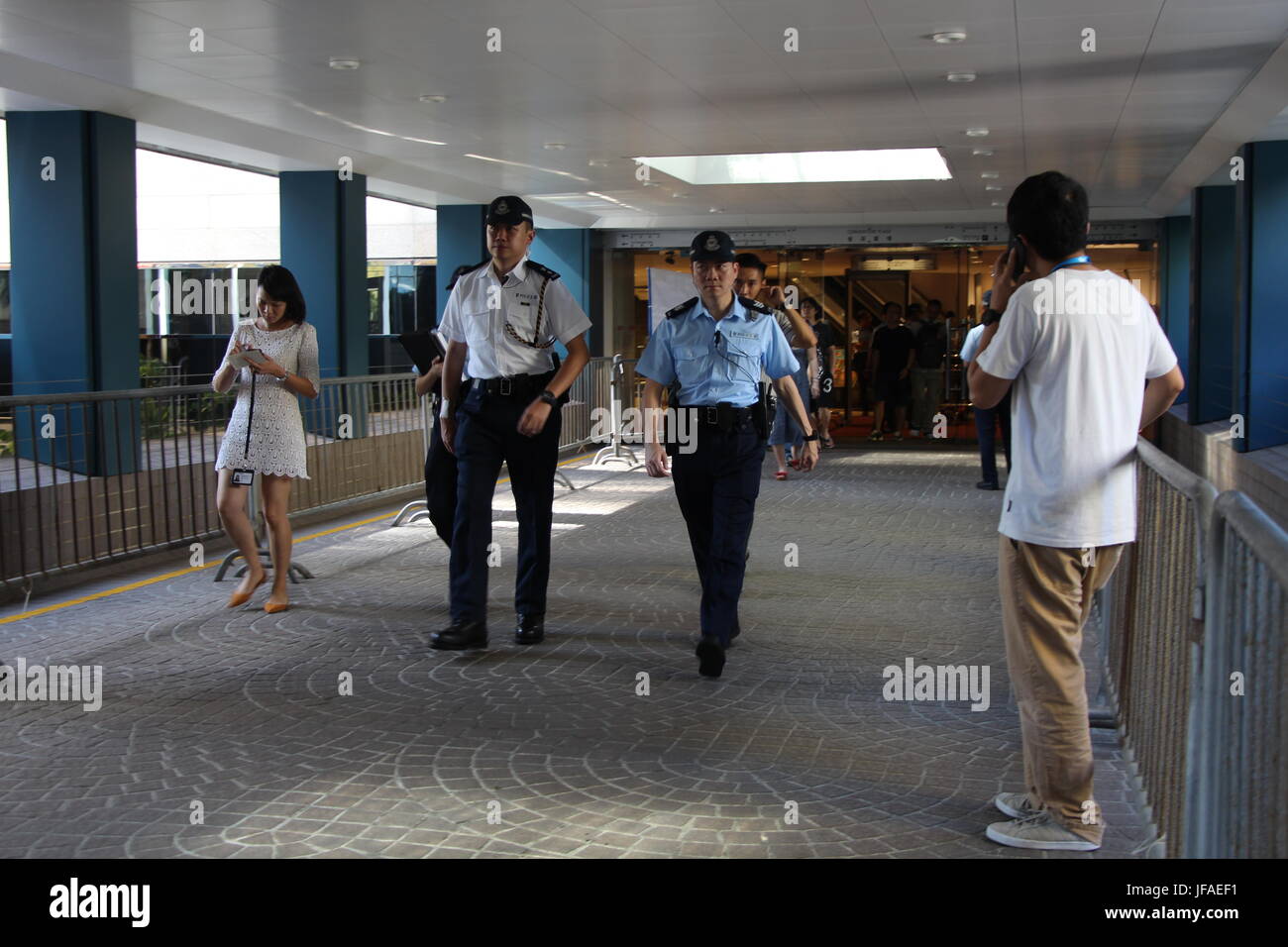 Right outside Convention Plaza in the heart of Hong Kong, the footbridge experienced great police presence on the first day of Xi Jinping's visit. Stock Photo