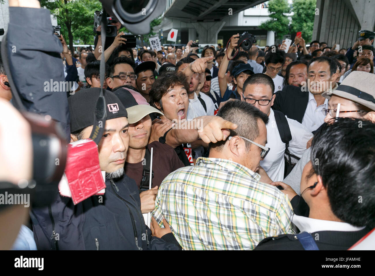 Tokyo, Japan. 1st July, 2017. Anti-Abe protesters clash with supporters of the Liberal Democratic Party of Japan during a campaign event for tomorrow's Tokyo Metropolitan Assembly election on July 1, 2017, Tokyo, Japan. A group of anti-Abe protesters appeared holding placards and chanting against the Prime Minister during the campaign event in support of LDP party candidate Aya Nakamura. Credit: Rodrigo Reyes Marin/AFLO/Alamy Live News Stock Photo