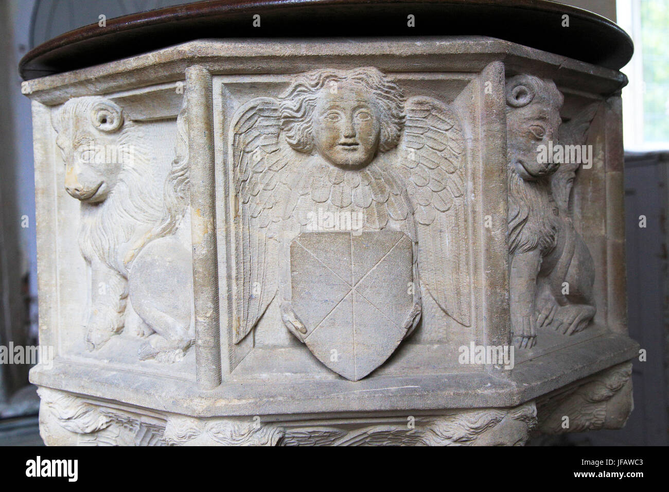 Carved stone lion and angels baptismal font, Church of Saint Gregory, Rendlesham, Suffolk, England, UK Stock Photo