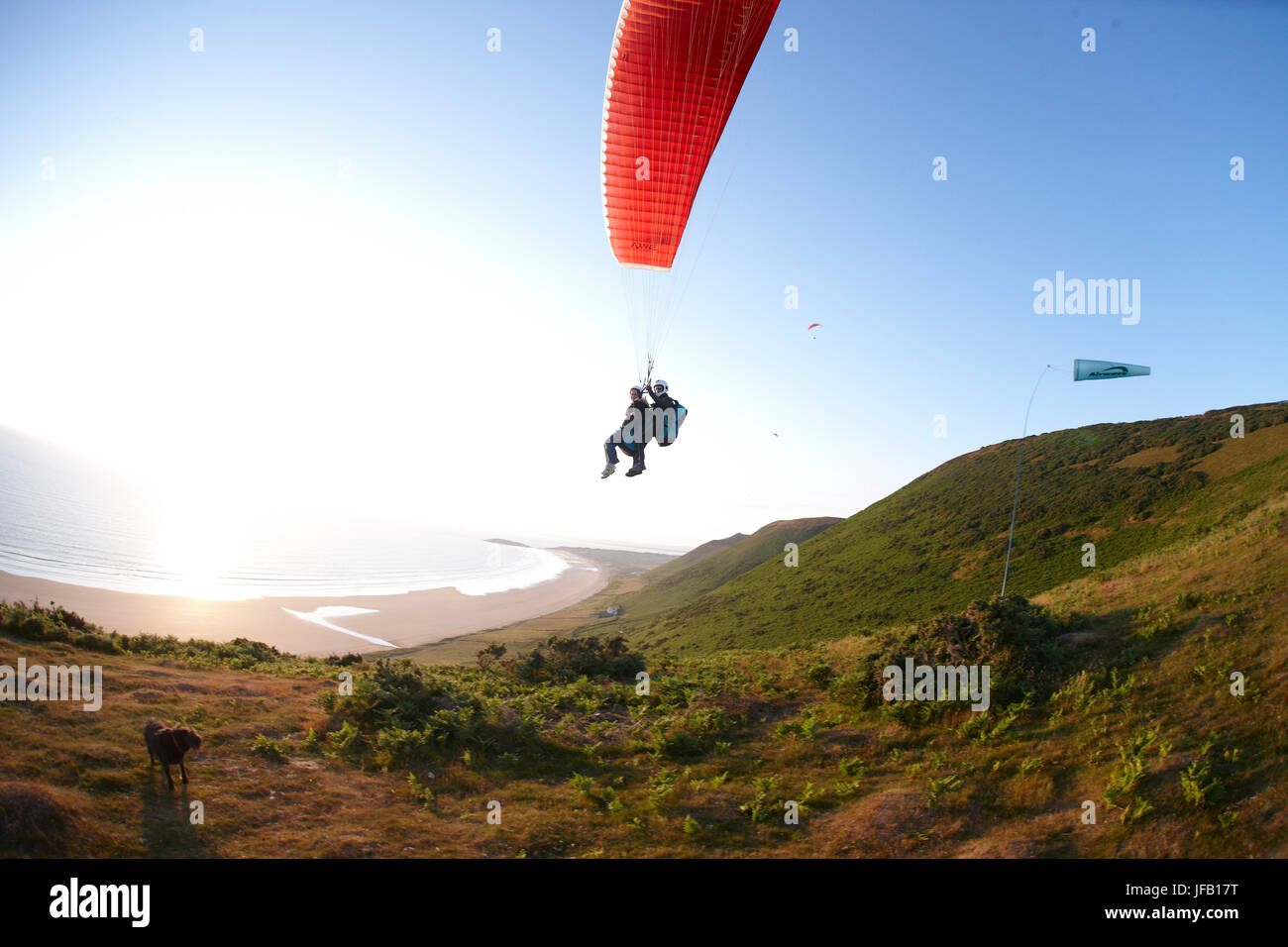 Tandem paragliding over the ocean Stock Photo