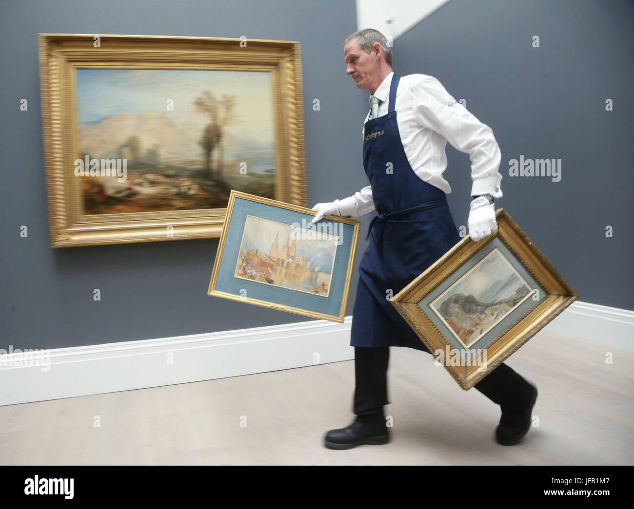 A technician carrying J.M.W Turner's Lichfield Cathedral, Staffordshire