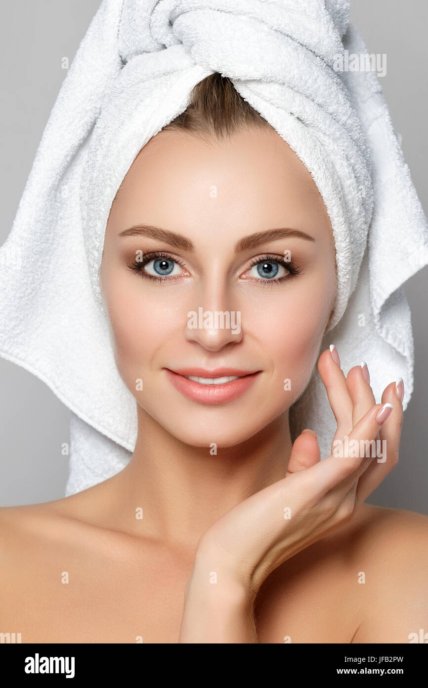 Portrait of young beautiful caucasian woman touching her face. Cleaning face, perfect skin. SPA therapy, skincare, cosmetology and plastic surgery con Stock Photo