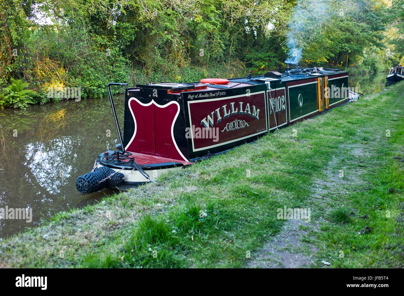 Narrowboat moored for the night with lit stove Stock Photo