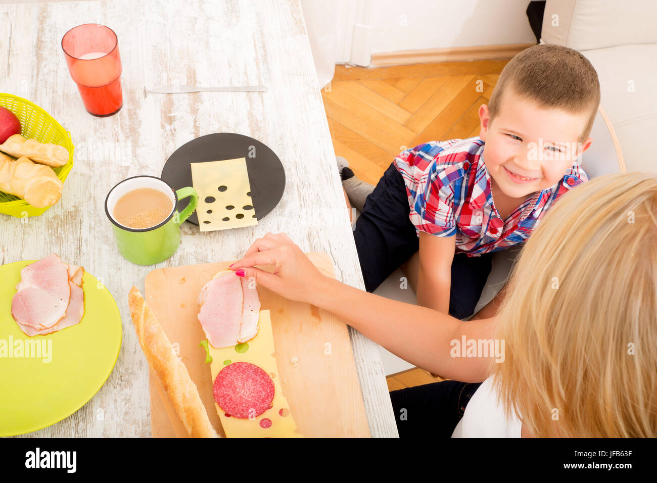 Happy family having breakfast at home Stock Photo - Alamy