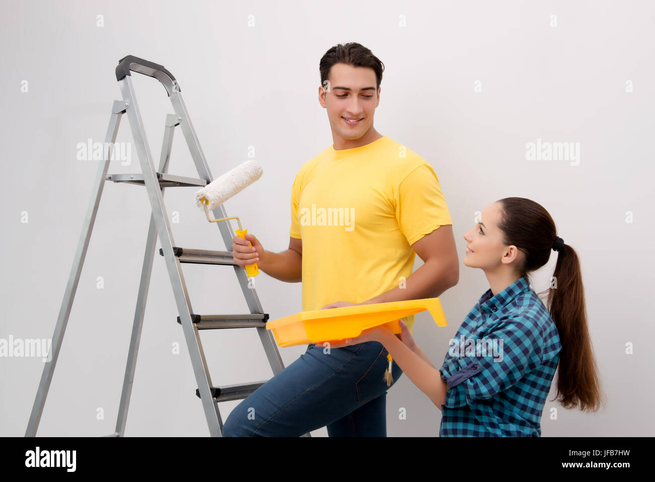 Young couple painting wall at home Stock Photo - Alamy