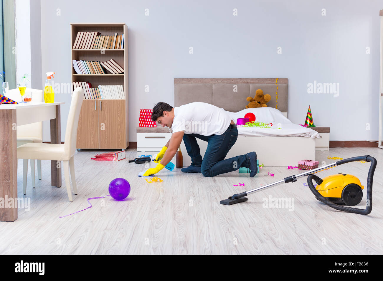 Man cleaning the house after christmas party Stock Photo - Alamy