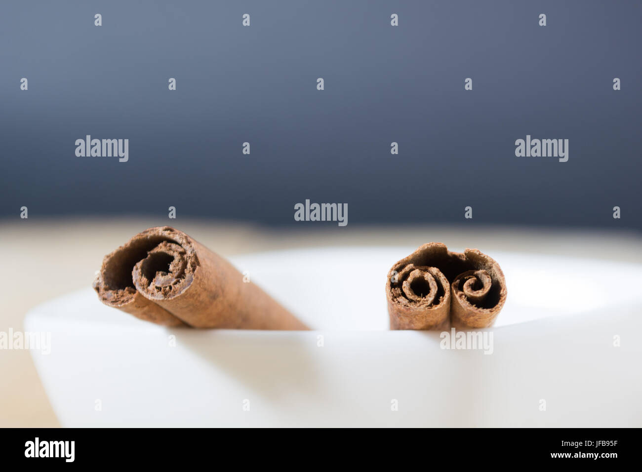 Cinnamon sticks in a white bowl Stock Photo
