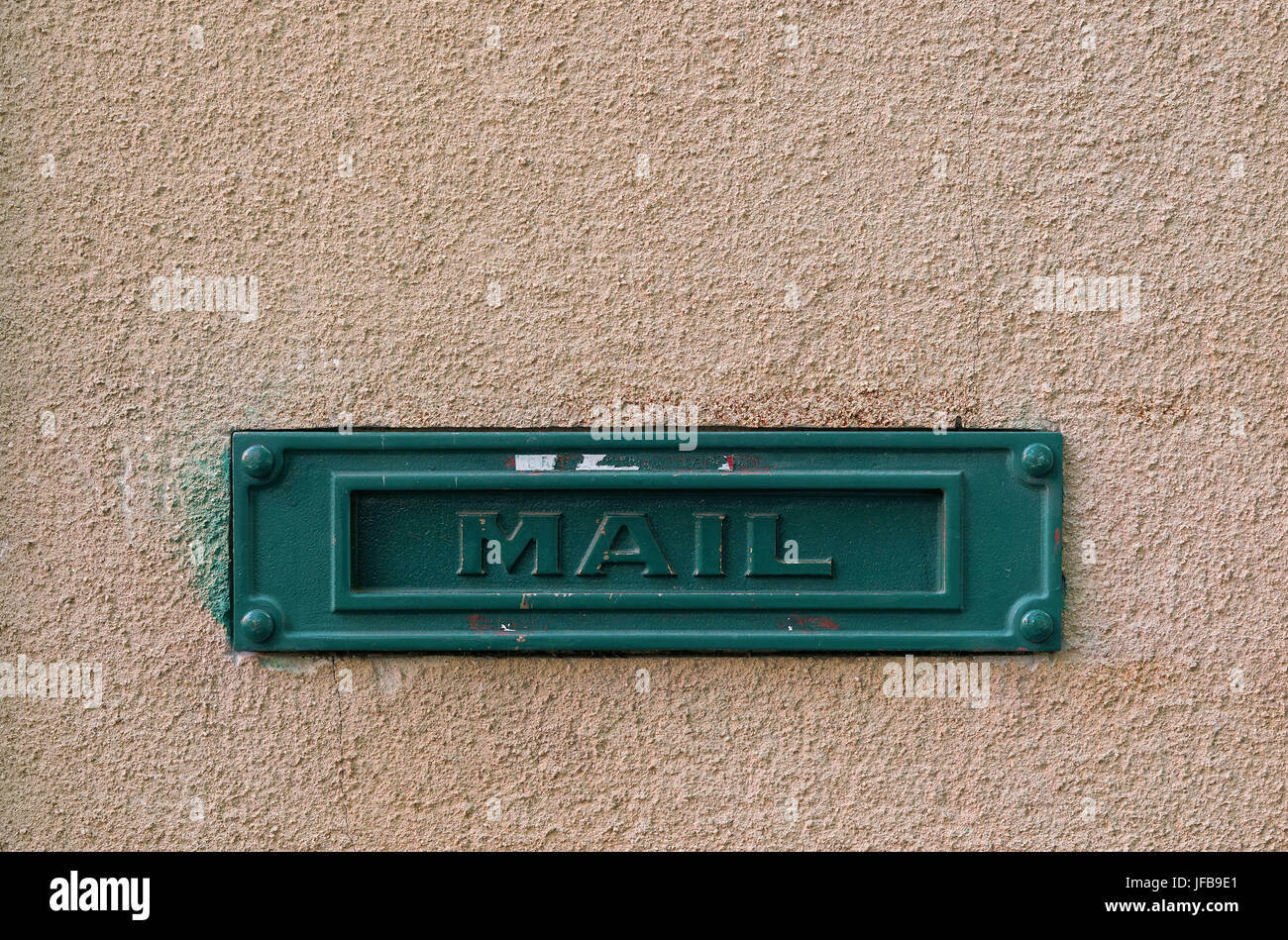 Green mailbox on the facade of a house Stock Photo