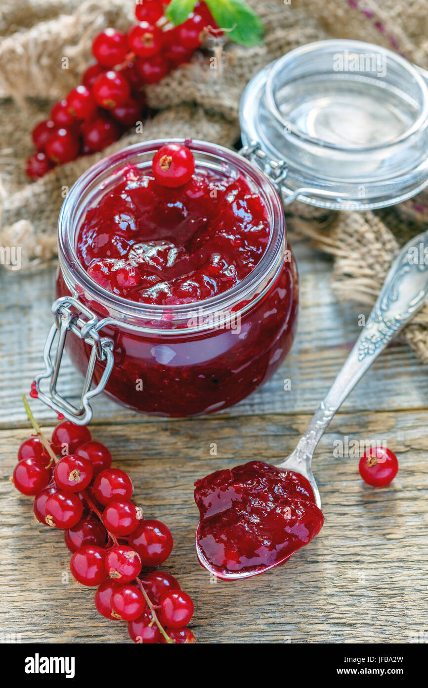 Jar and teaspoon with homemade red currant jam Stock Photo Alamy