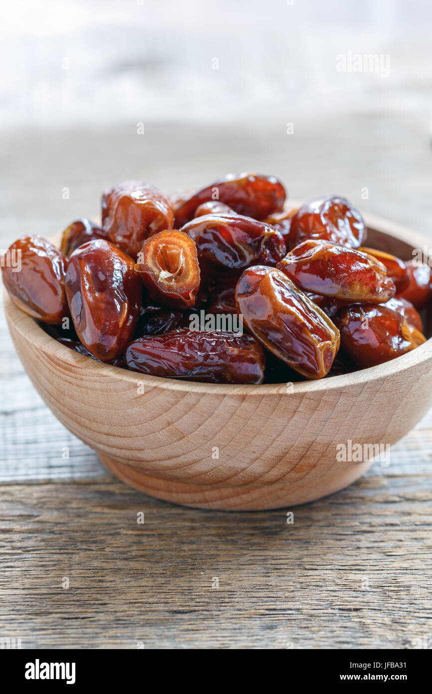 Wooden bowl with dried date fruit. Stock Photo