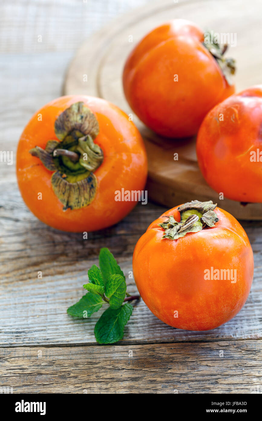 Persimmon and fragrant mint. Stock Photo