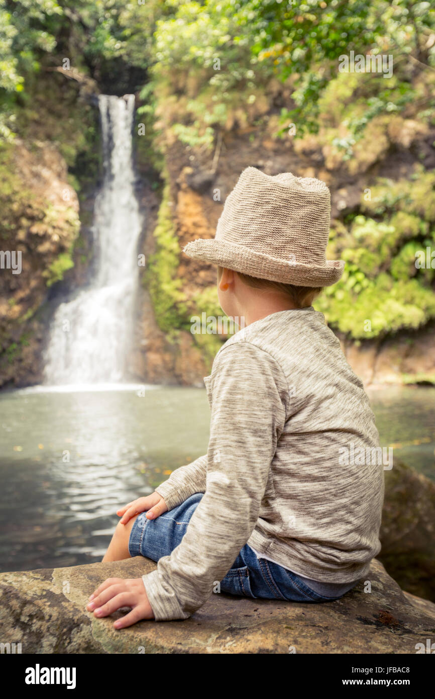 Child looking Chamouze waterfall. Mauritius Stock Photo
