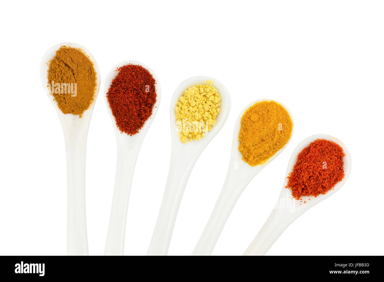 Various seasoning spices on metal spoons Stock Photo