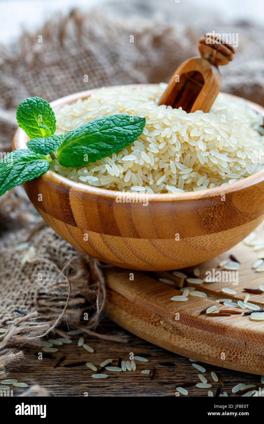 Long grain rice in a wooden bowl. Stock Photo