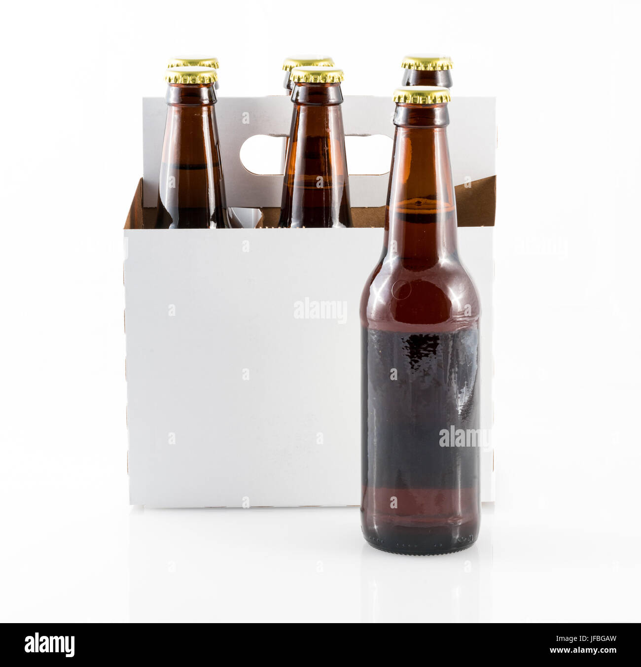 Five bottles of beer in cardboard carrier Stock Photo