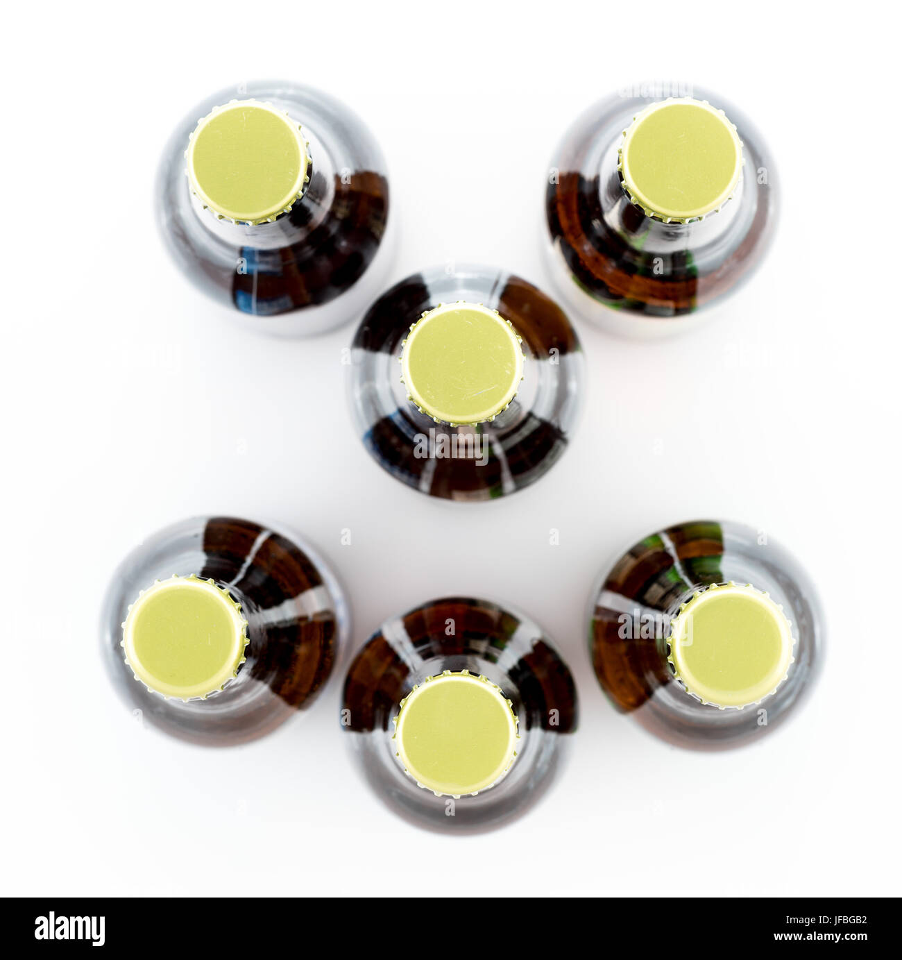 Six bottles of beer with caps facing camera Stock Photo